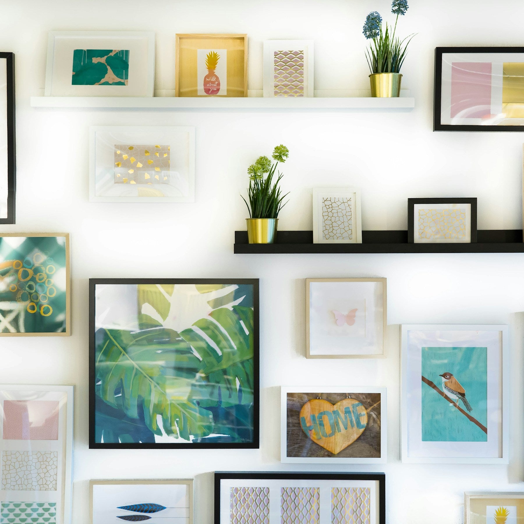A collected gallery wall featuring botanical artwork