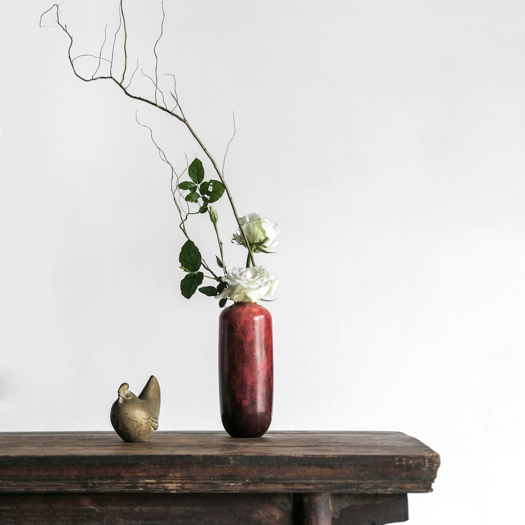 Rowan side table styled with a sculptural vase