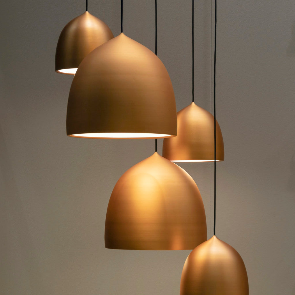 Aged brass Solis dome pendant lights in a group