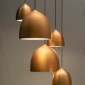 Aged brass Solis dome pendant lights in a group