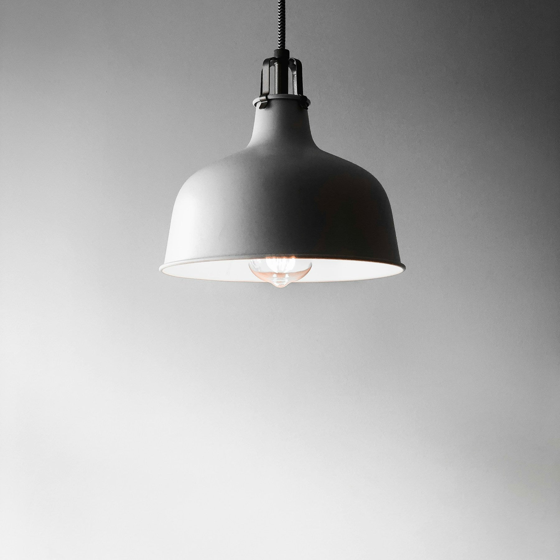 Slate Solis pendant light against a light wall