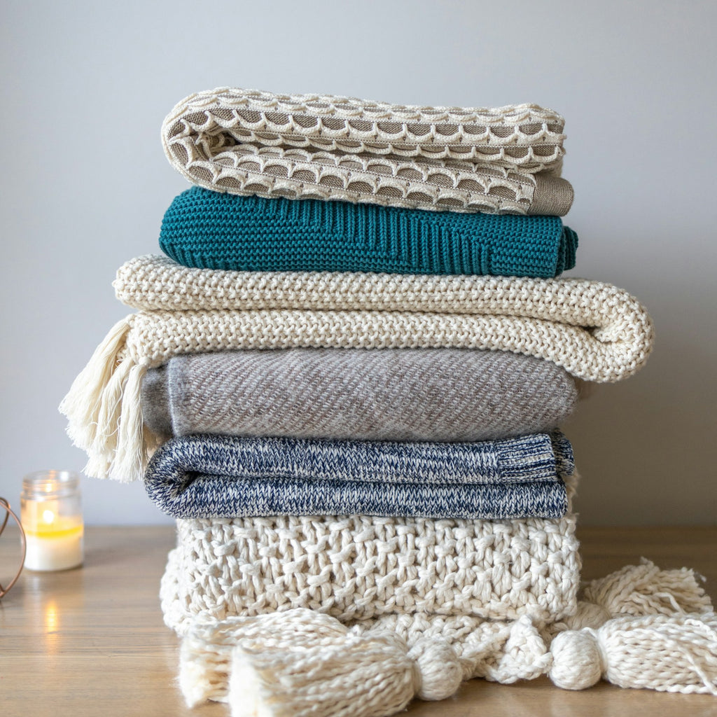 Folded chunky knit throws in layered neutral colors