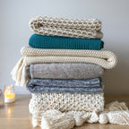 Folded chunky knit throws in layered neutral colors