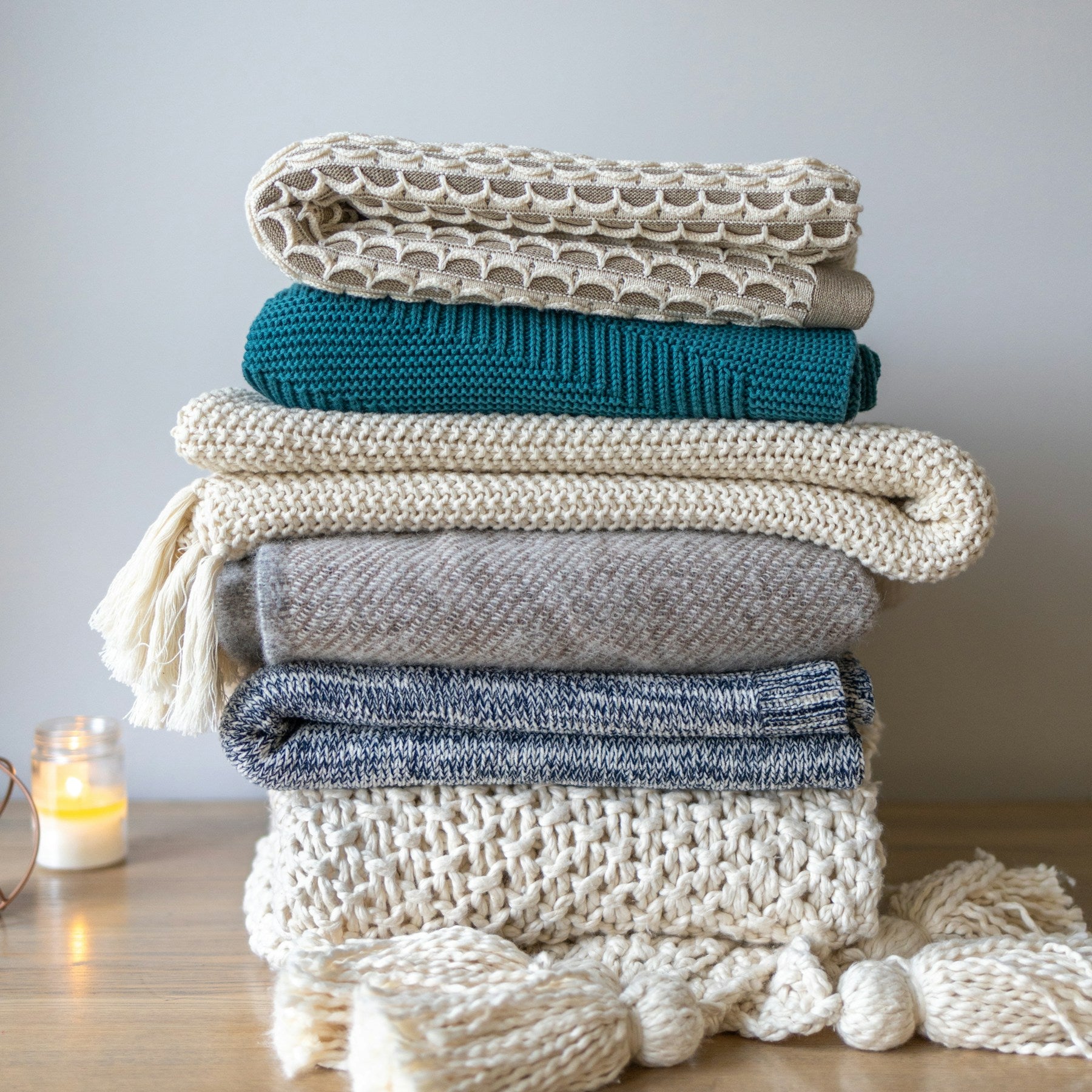 Folded chunky knit throws in layered neutral colors