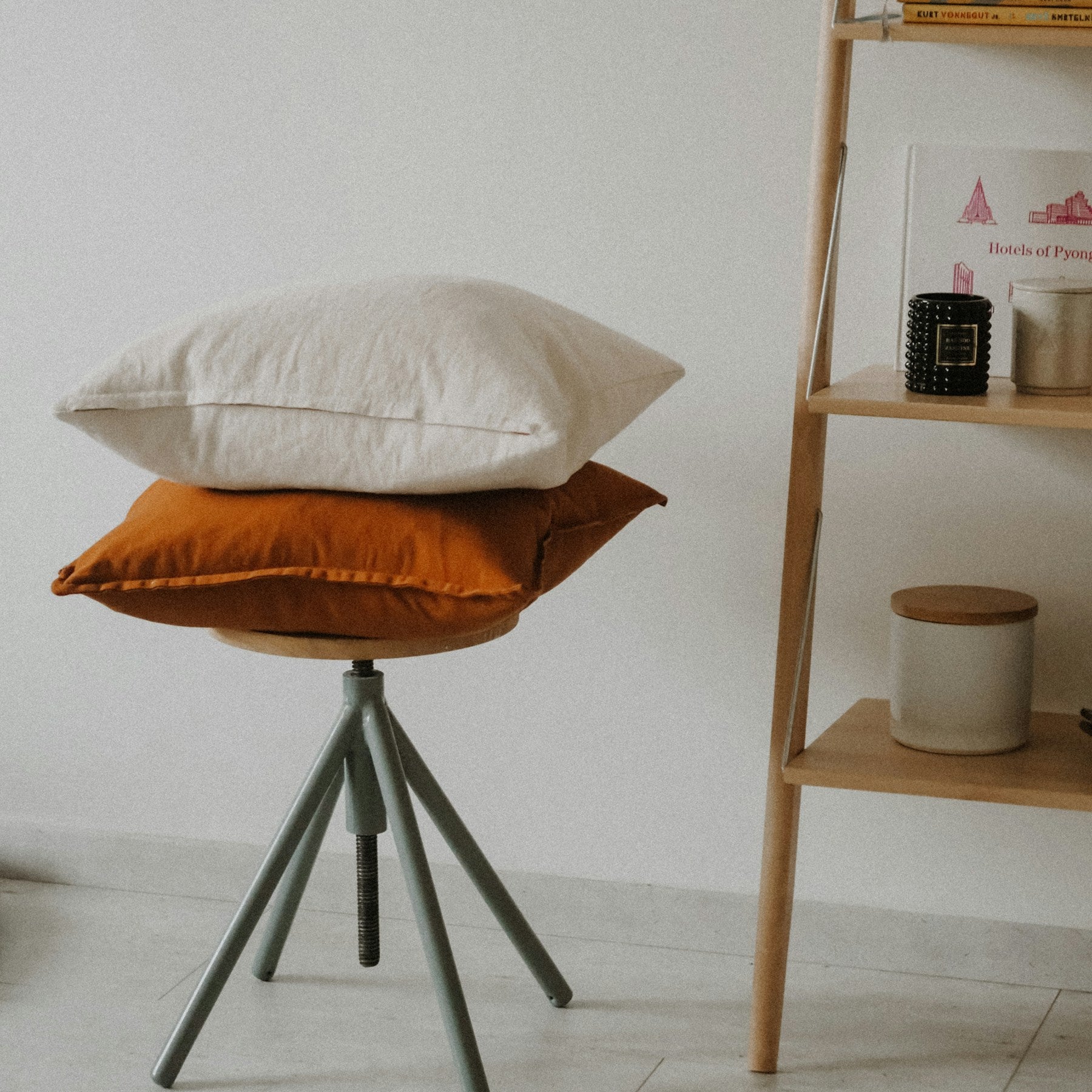 Vale linen cushions in oat and terracotta on a stool