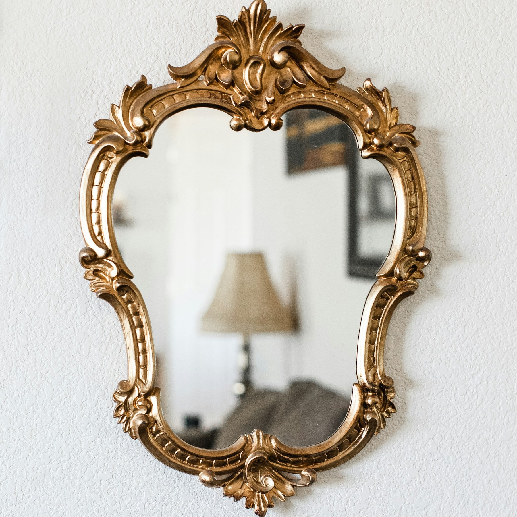 Elara ornate antiqued wall mirror in a bright interior